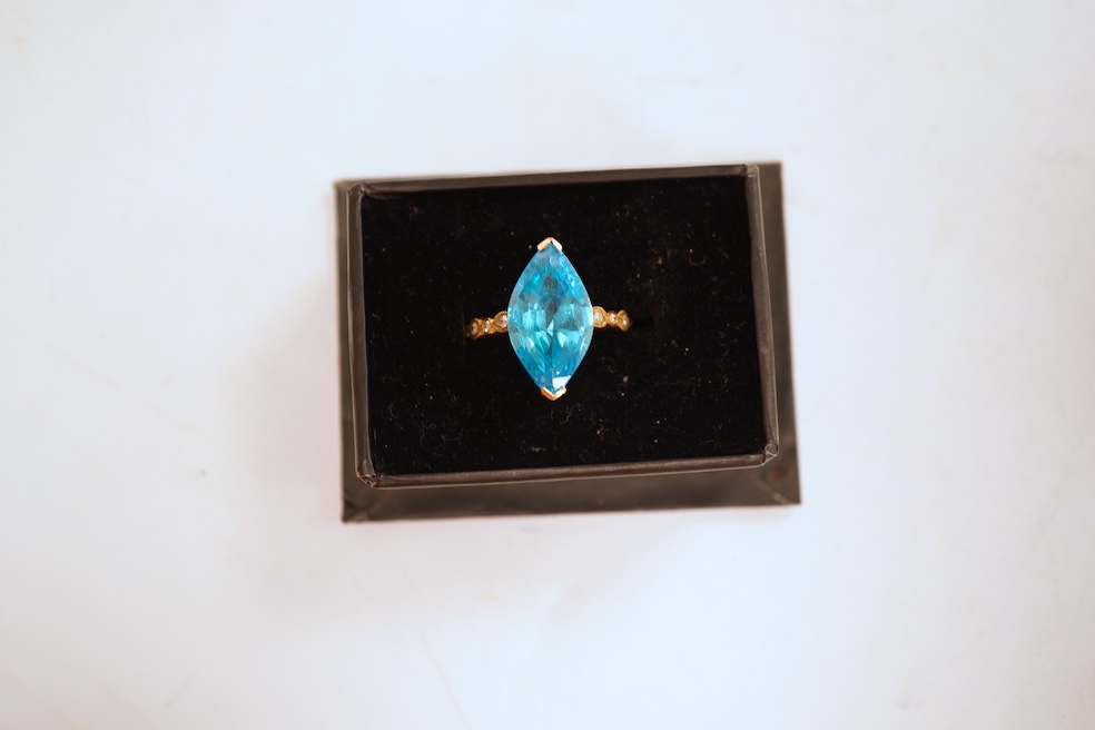 A cubic zirconia and diamond ring, set with a marquise-shaped blue cubic zirconia, to shoulders set with brilliant-cut diamonds, mounted in gold, size Q1/2, stamped 585, gross weight 8 grams, Condition: minor discolorati